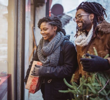 man and woman smiling and walking